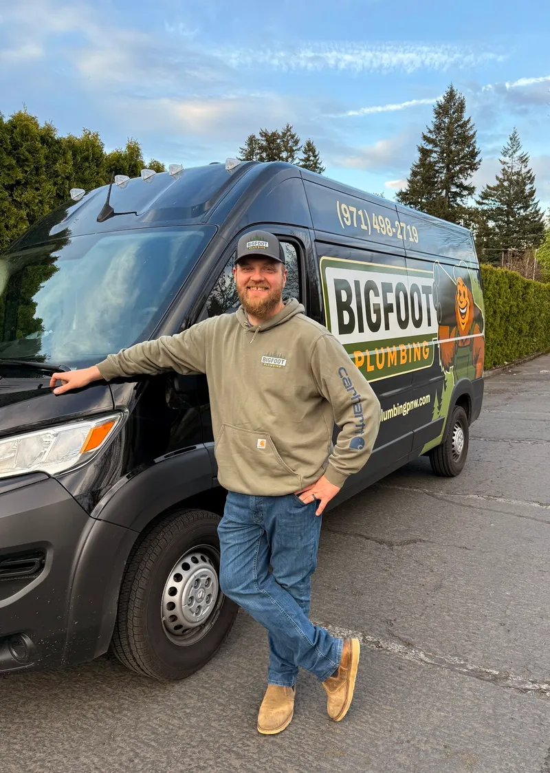 Kevin Brain, owner of Bigfoot Plumbing, standing beside his branded service van in Sandy, Oregon — family-owned, licensed plumber (CCB# 257405) serving Sandy, Boring, Gresham, and the Pacific Northwest